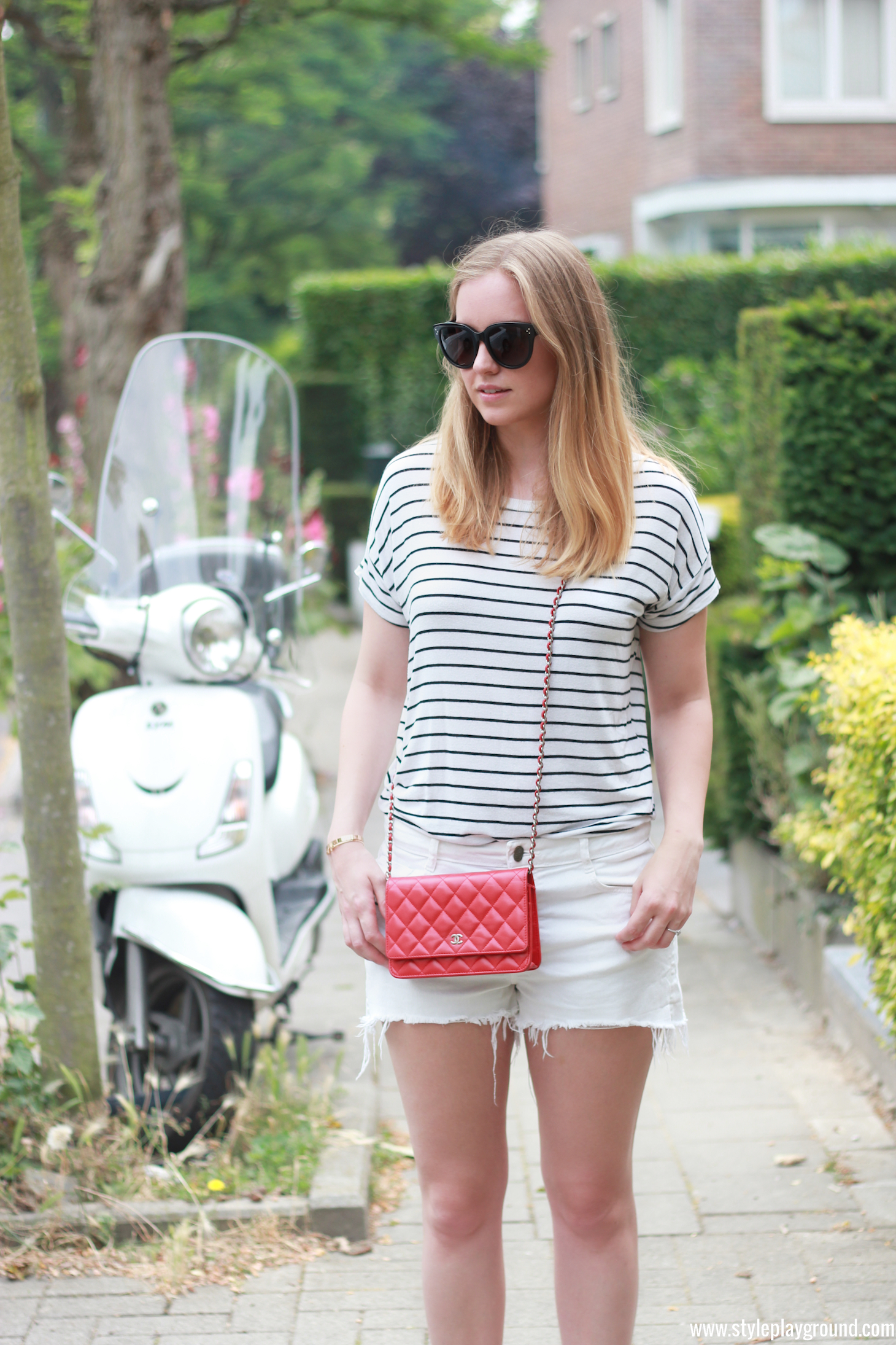 Axelle Blanpain from Style playground is wearing Zara shorts & t-shirt, white Converse sneakers, Chanel red WOC, Celine Audrey sunglasses